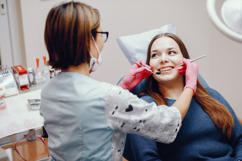 dentist checking a lady's teeth
