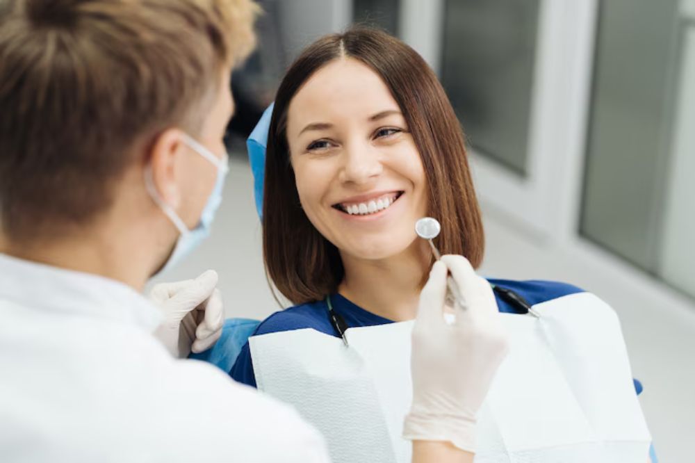 a lady is smiling after getting dental veneer treatment