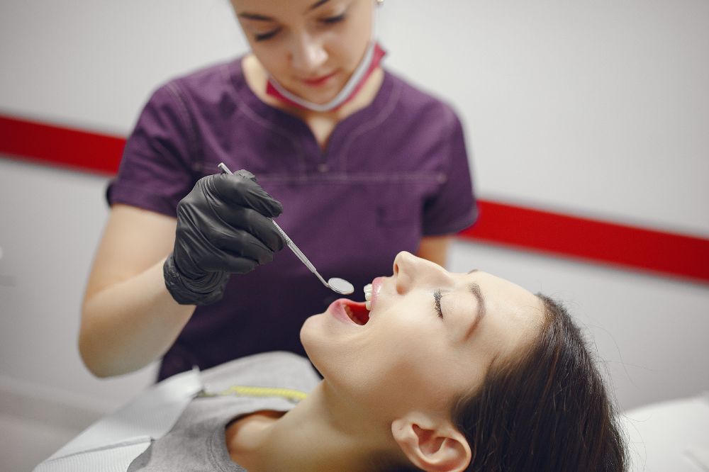 a lady is getting composite filling treatment